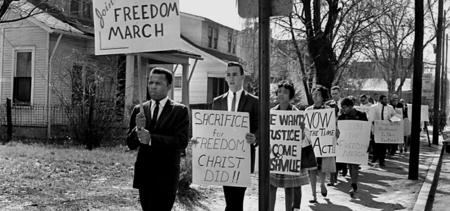 men and women marching holding signs 