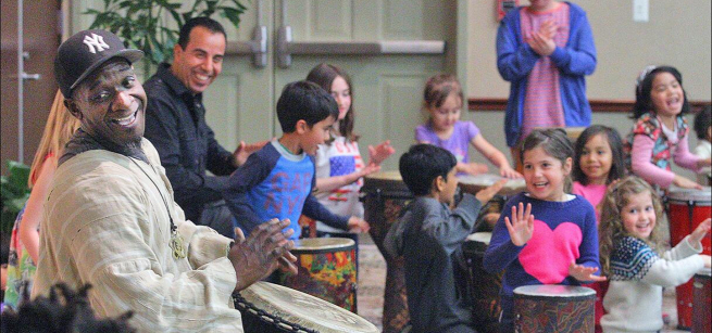 Happy people drumming together