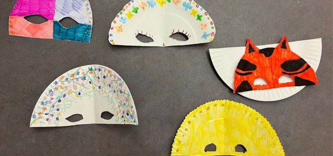 Paper plates decorated as Mardi Gras Masks