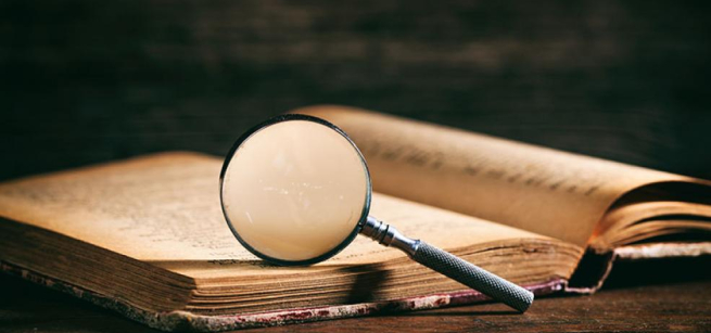 book with a magnifying glass