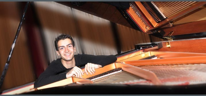 Riyad Nicolas seated at a piano