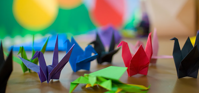 Colorful origami cranes placed on a table