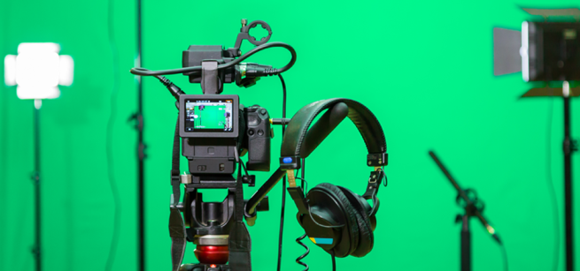 camera equipment in front of a green screen