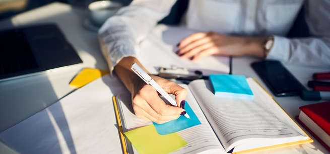 hands writing in a journal