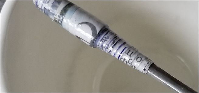 close up of a paper bead made from newspaper