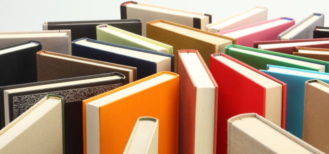 Books standing on end arranged randomly.