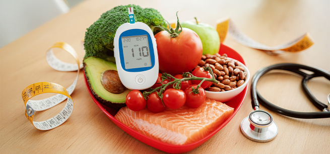 healthy foods and a stethescope and heart monitor