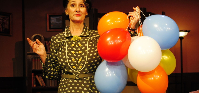 A. Einstein holding balloons.