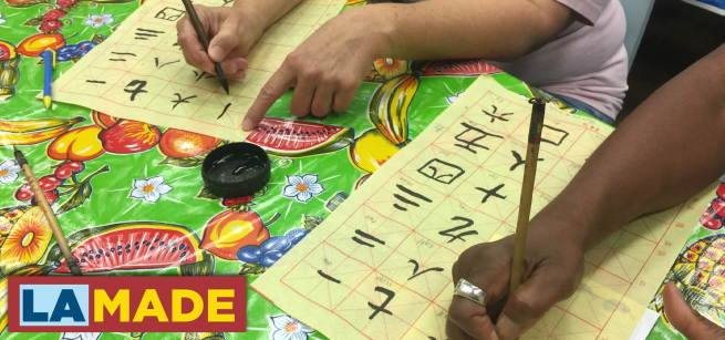 hands writing Chinese characters