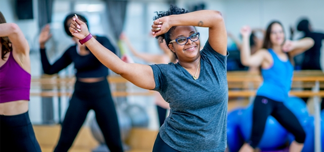 Women are waving their arms while exercising.