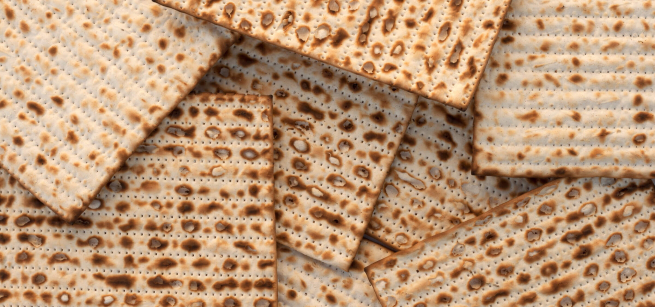 Matzah bread unevenly stacked in a pile. 