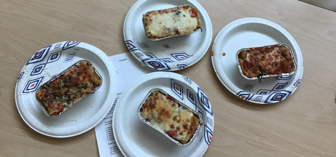 Four individual containers of teen-made lasagna.