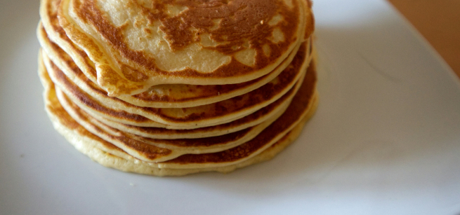 a stack of pancakes on a white plate. photo by Matthias Reumann on Unsplash