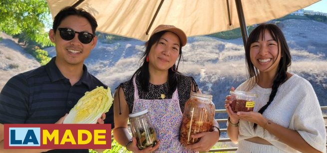 three people holding up jars and vegetables