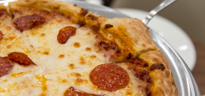 An up-close image of a pepperoni pizza