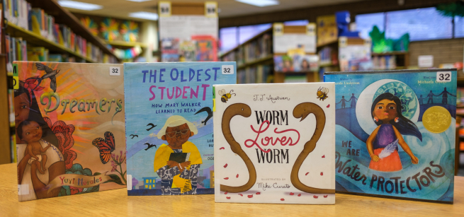 Children's Picture Books shown on a wooden table.