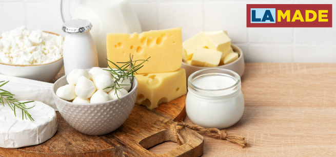 soft cheeses displayed on a wood table