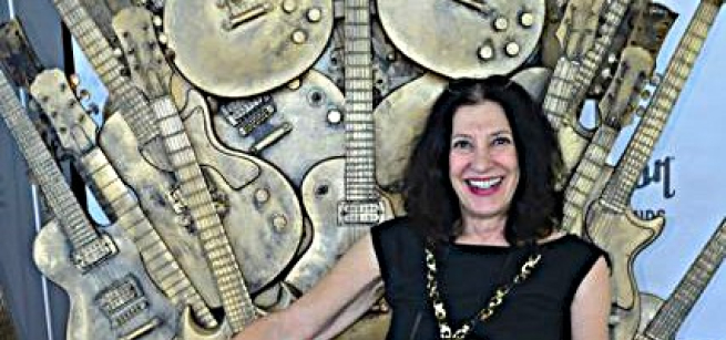 woman sitting in front of guitars