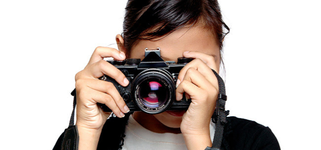 Woman hodling a camera in front of her face