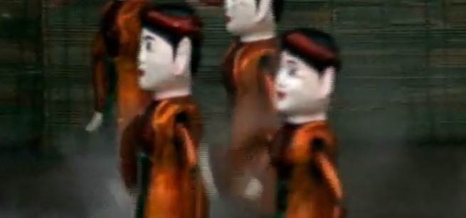 Vietnamese Water Puppets with black hair and black and gold outfits. 