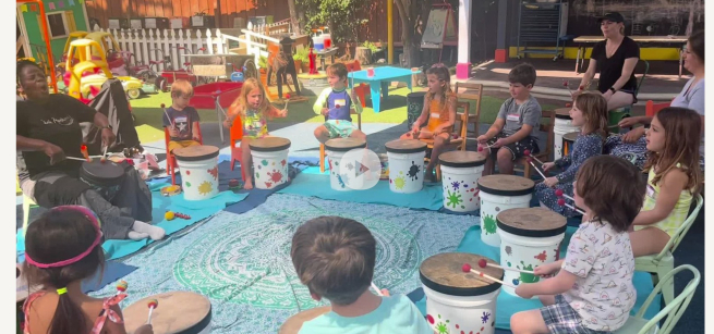 children sit in a circle with drums made out of cans in front of them
