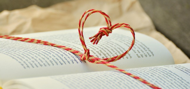 A book wrapped with string in the shape of a heart 