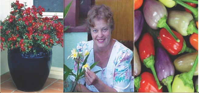 Woman holing flowers next to a vase with flowers and vegetables