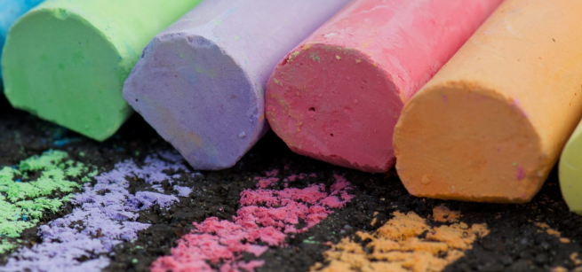 A row of coloring chalks marking the pavement.