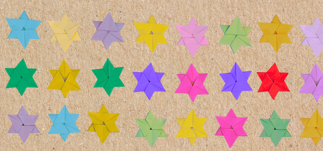 Paper Star of David origami in multiple colors on a brown background