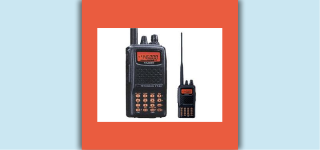 Two black HAM radios with orange screens and antennae sit next to each other on a white background.