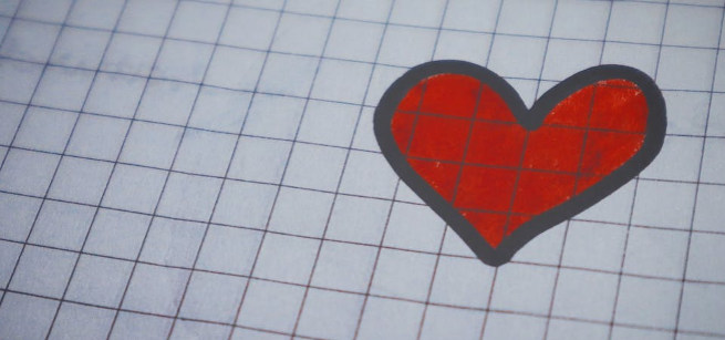 red heart with black outline drawn on graph paper