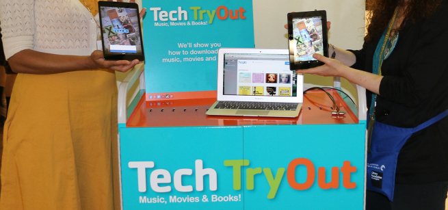 blue cart with writing on the front and a tablet and computer on the top shelf