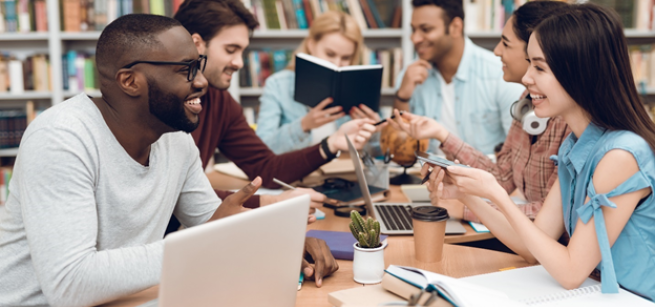 Group of adults meeting with laptops