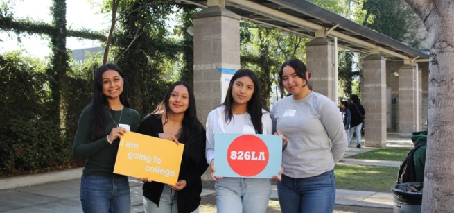 College-Bound Teens Holding 826LA Signs