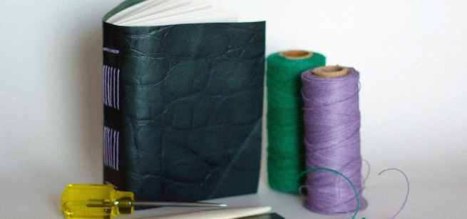 homemade book with thread spools