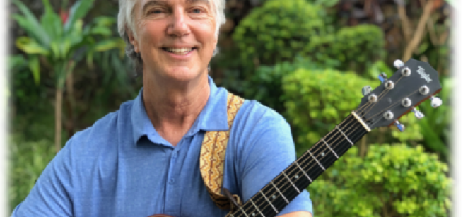 musician Craig Newton holding guitar