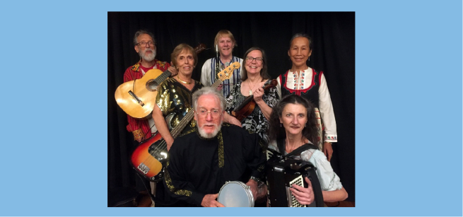 A group of seven folk musicians holding their instruments.