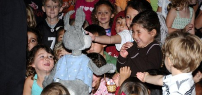 Children watching a puppet show.