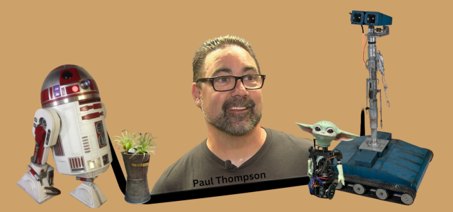 Image of Paul Thompson being surrounded by some of his robotic creations