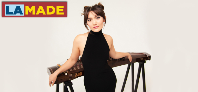 musician posing in front of their instrument