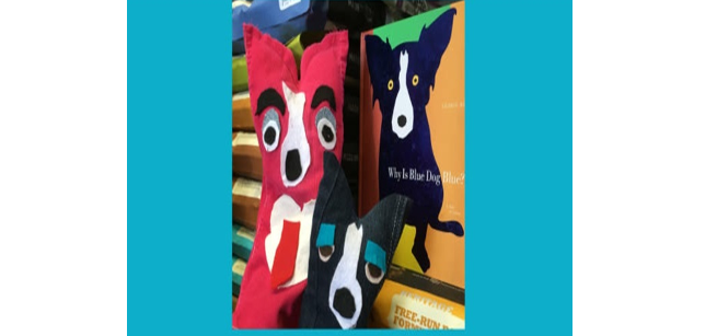 Two dog puppets with a book