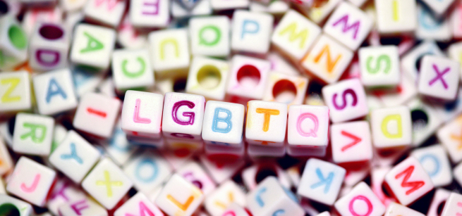 a pile of colorful letter beads with the initialism LGBTQ in the middle