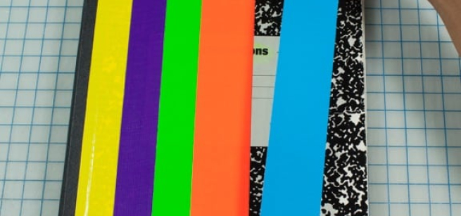 Image of a notebook being decorated with craft tape