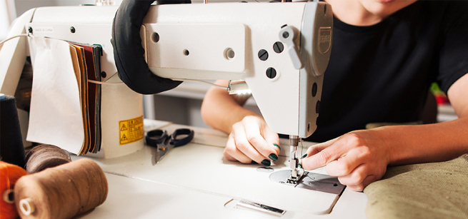 A person working on a sewing machine.
