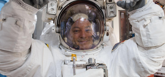 NASA astronaut Scott Tingle wears a U.S. spacesuit inside the Quest Airlock preparing for his first spacewalk