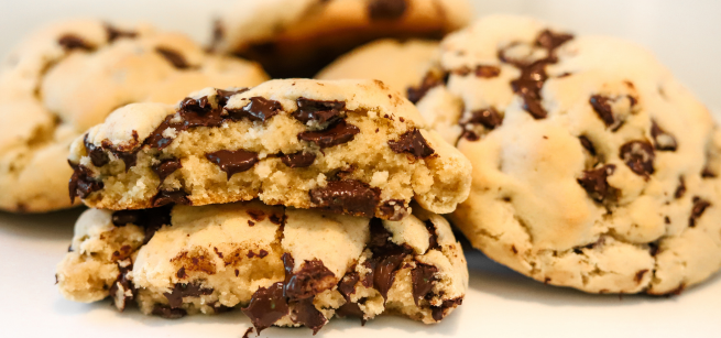 an up-close image of several chocolate chip cookies