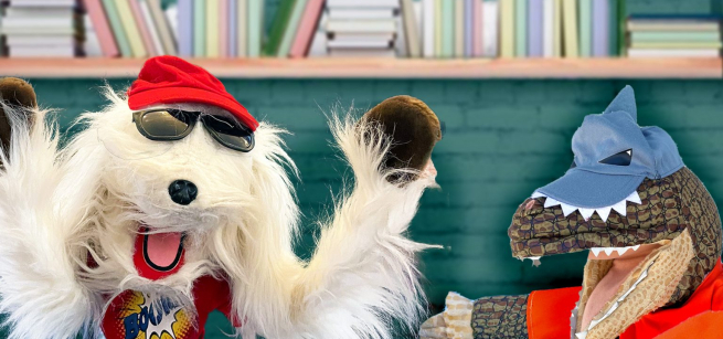 Puppet dog with red cap and puppet crocodile with blue cap