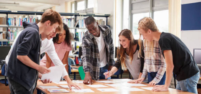 teens working on a pjoject in a library