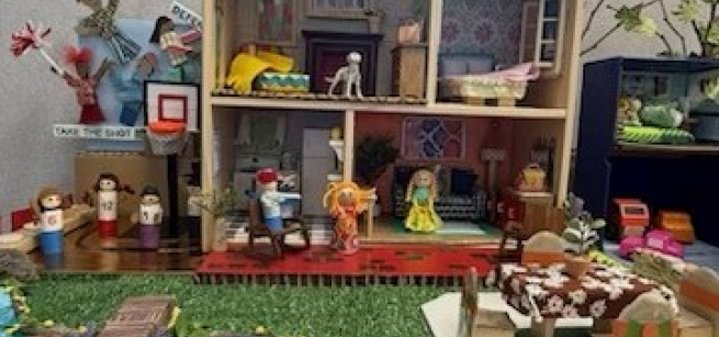 A homemade dollhouse made of upcycled craft materials