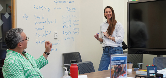 Instructor and student in a classroom.